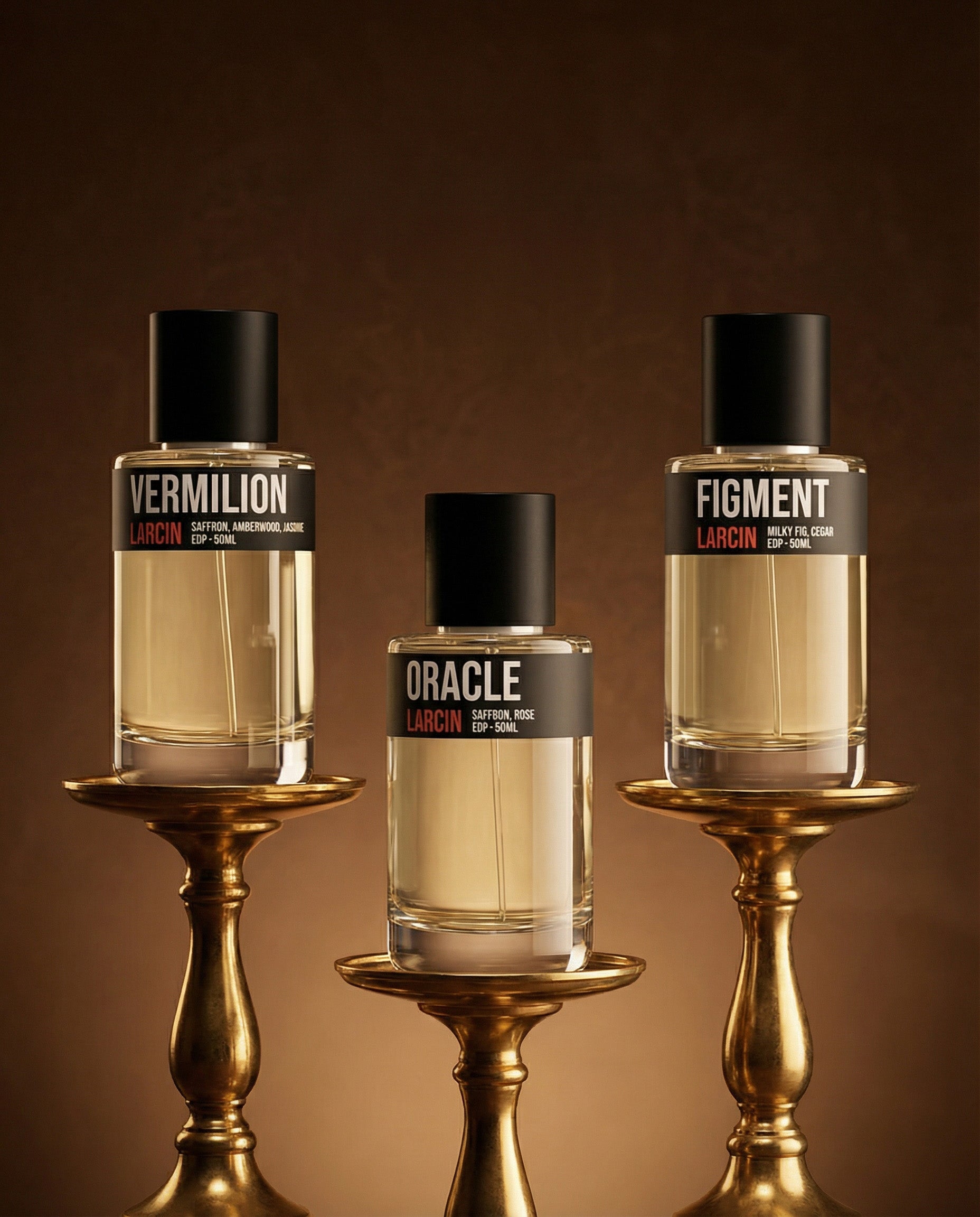 Three perfume bottles labeled 'Vermilion', 'Oracle', and 'Figure' on gold stands against a brown background.